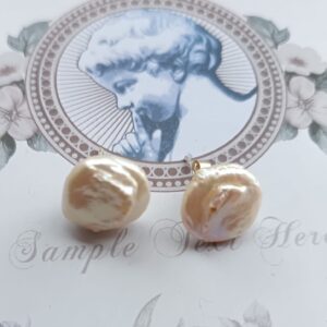 Cream coin pearl studs with Sterling silver posts.